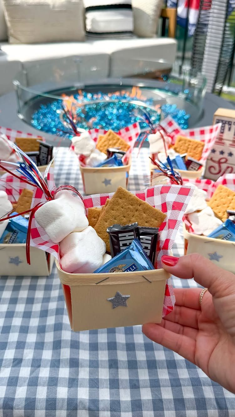 S'mores kits in small tan baskets with red checkered liners on a table