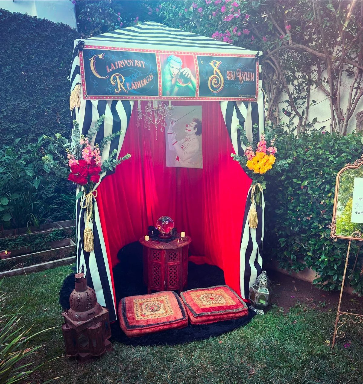 Mystical fortune teller tent with striped fabric, red curtains, and a crystal ball.
