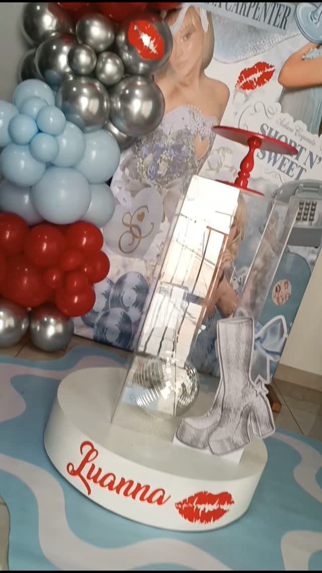 Party decorations with red, blue, and silver balloons and Short n' Sweet backdrop.