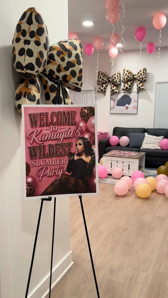 Welcome sign for a slumber party in a room with pink balloons and leopard decor.