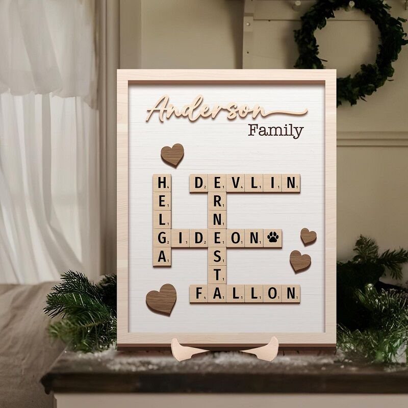 Custom family sign with wooden letter tiles spelling names in a crossword layout.