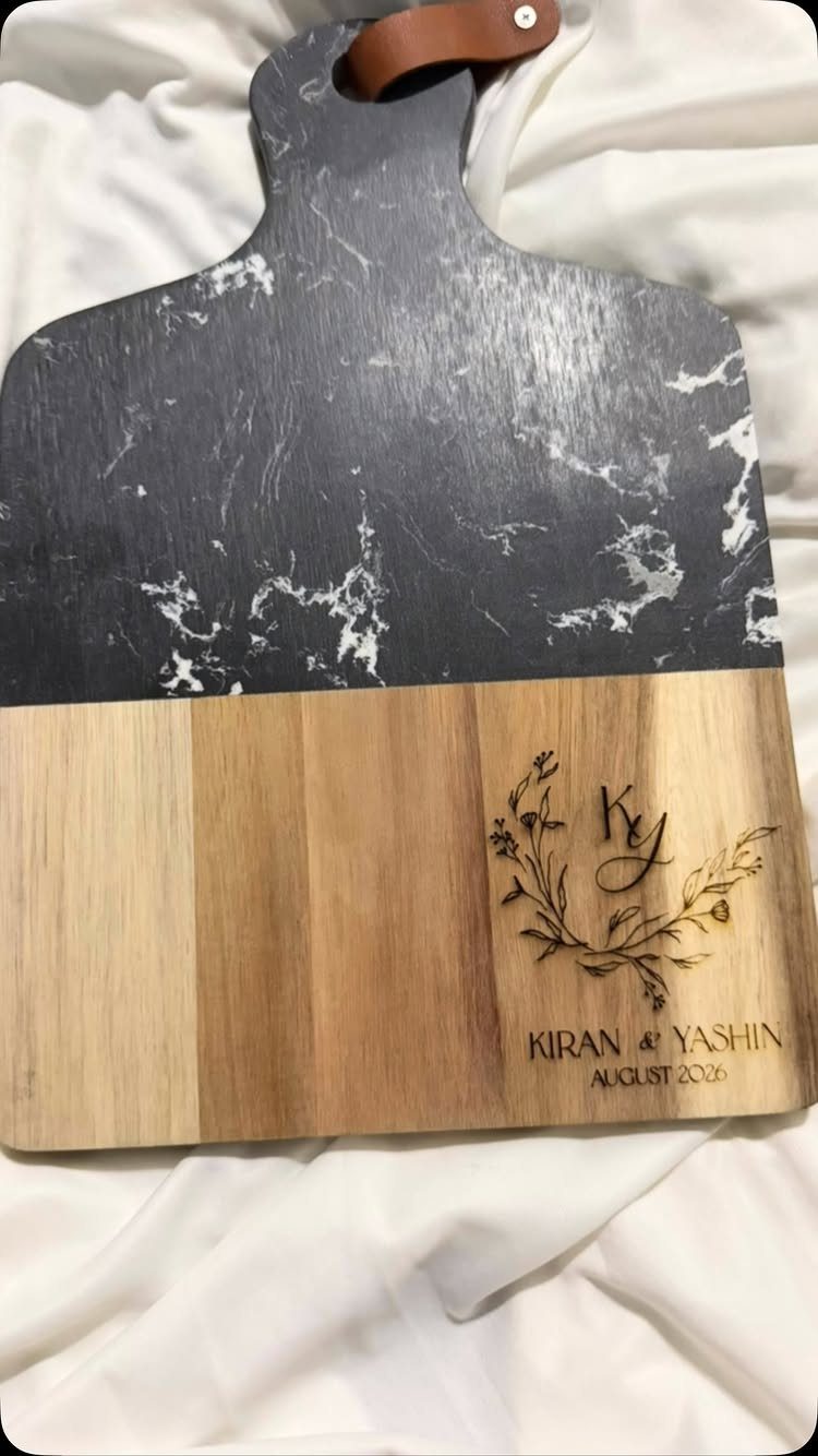 Engraved marble and wood serving board with names and wedding date.
