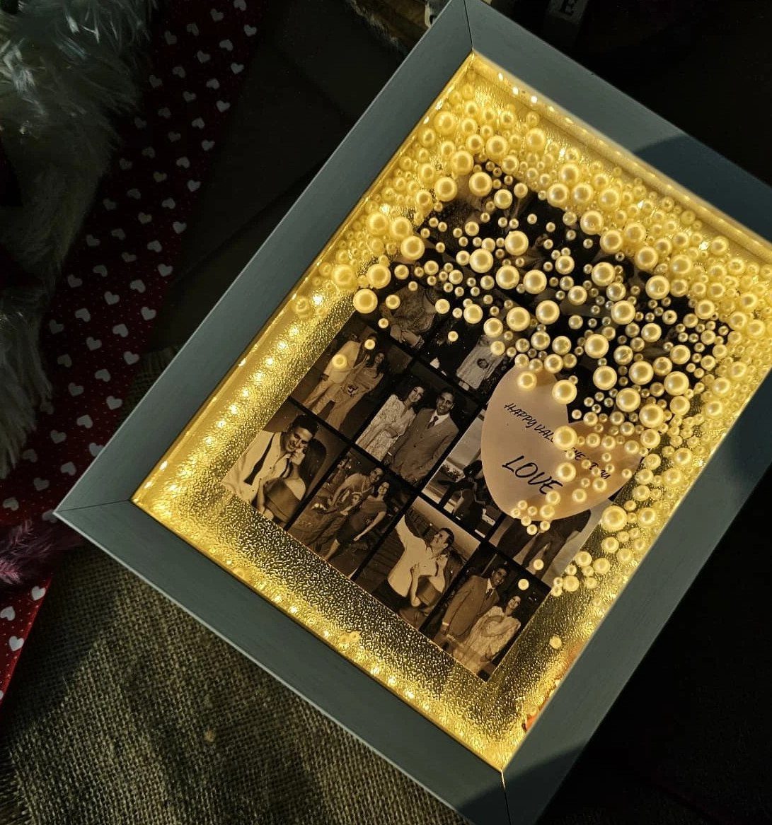 Illuminated grey frame with black and white photos, white pearls, and a heart.