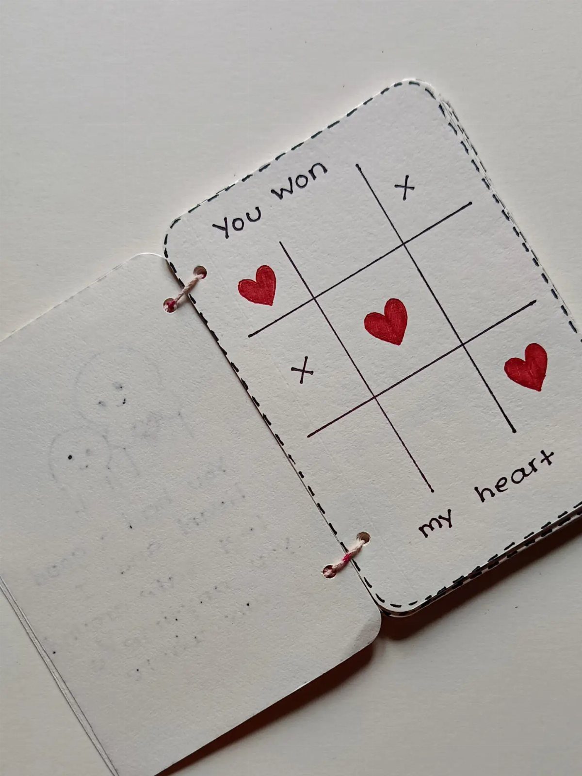 Handmade tic-tac-toe card with red hearts and the words You won my heart.