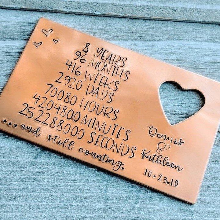 Engraved copper anniversary plaque listing time elapsed in years, months, and seconds.