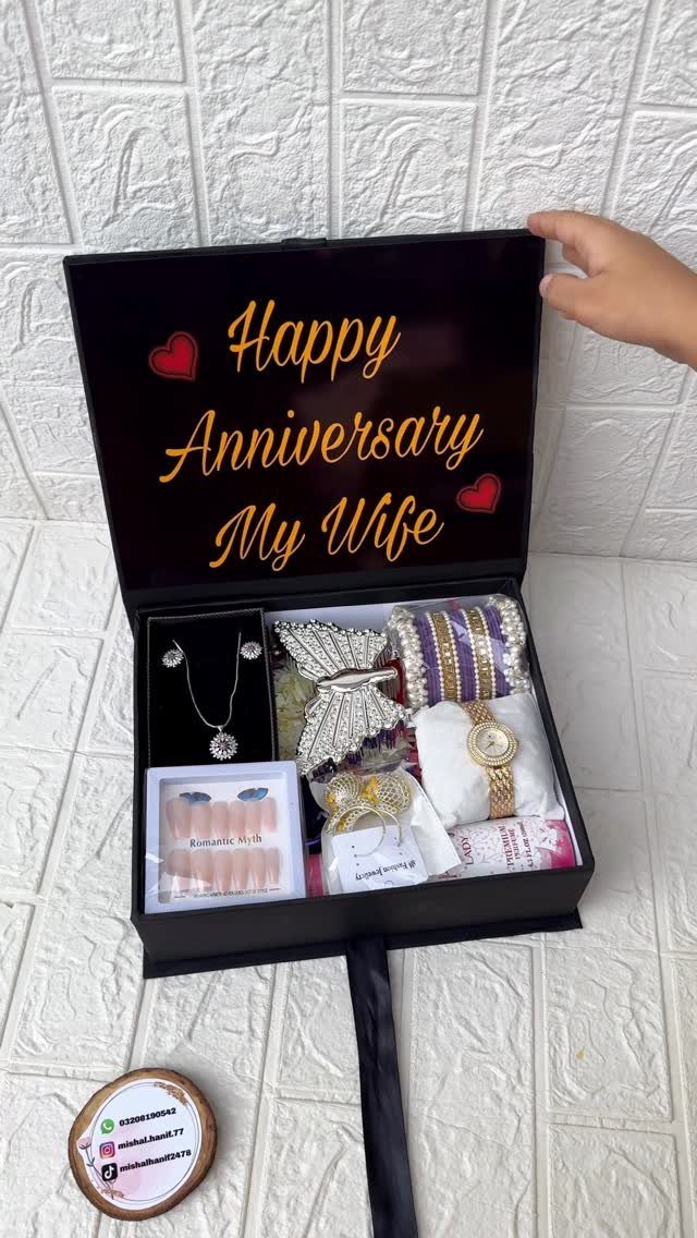 Open black gift box with jewelry and anniversary message for a wife