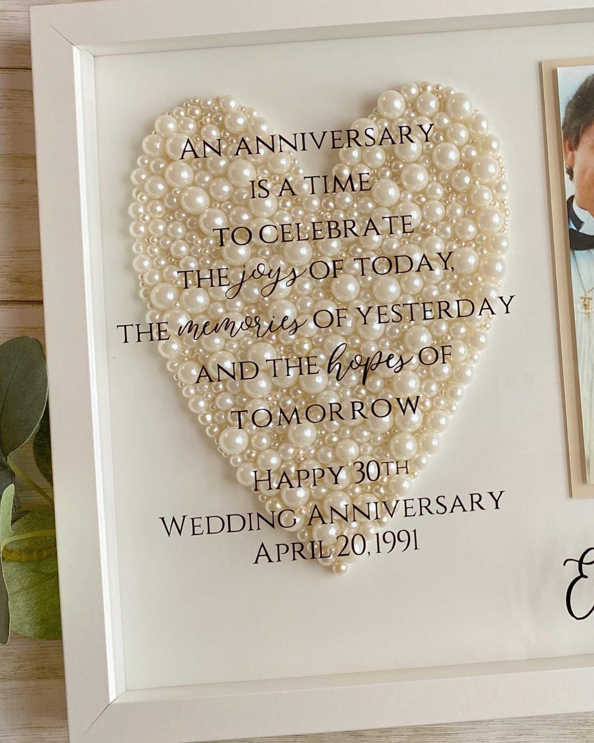 Heart made of white pearls in a frame for a 30th wedding anniversary.